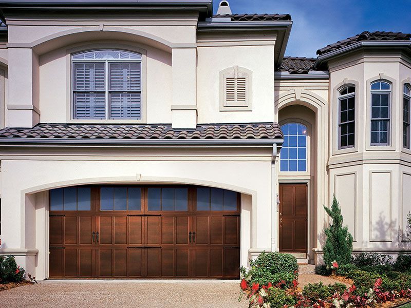 beige home exterior with white garage doors