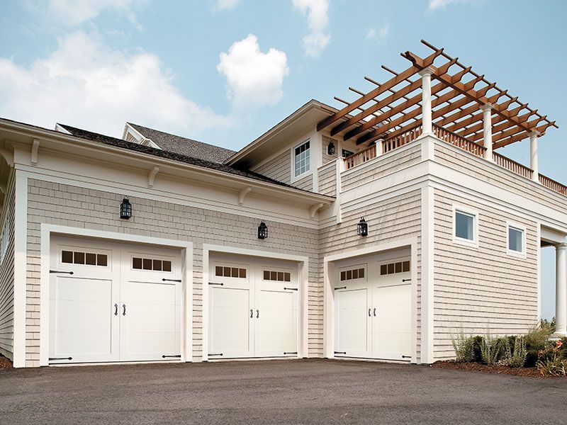 beige home exterior with white garage doors