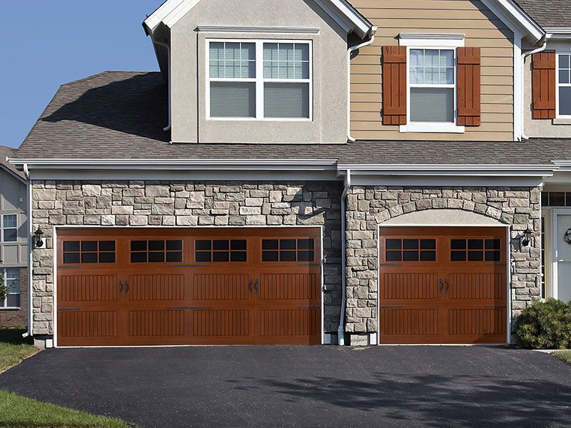 beige home exterior with white garage doors