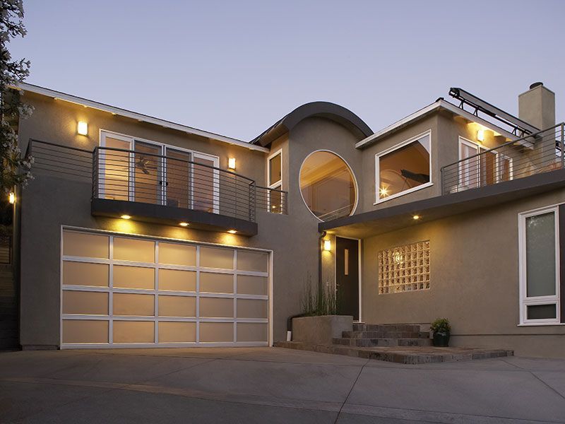 beige home exterior with white garage doors