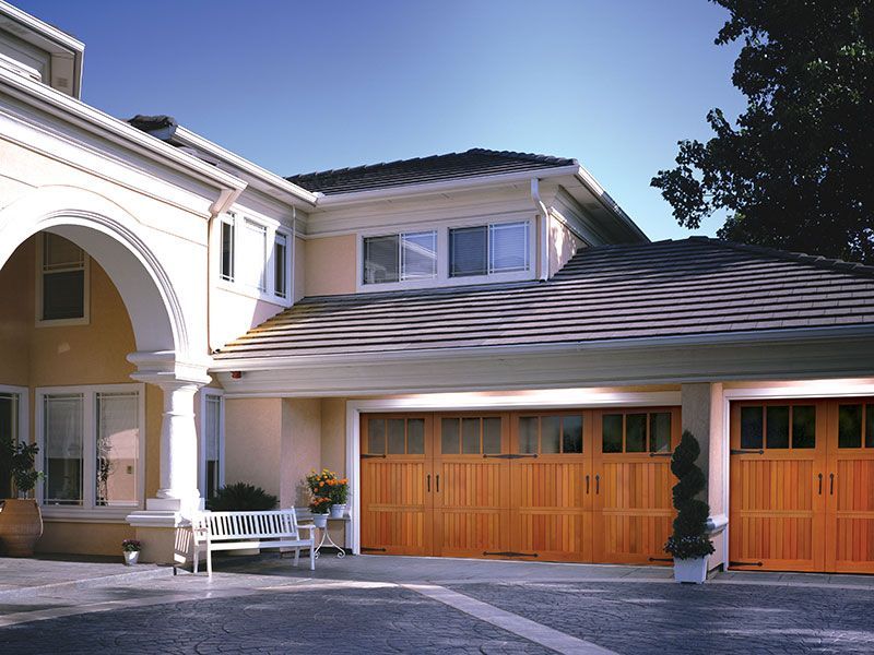 beige home exterior with white garage doors