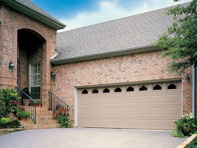 beige home exterior with white garage doors