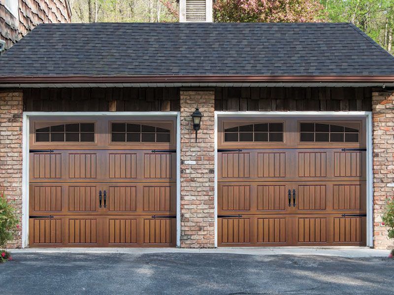 beige home exterior with white garage doors