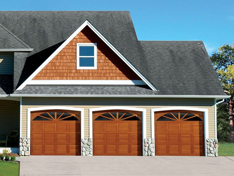 beige home exterior with white garage doors