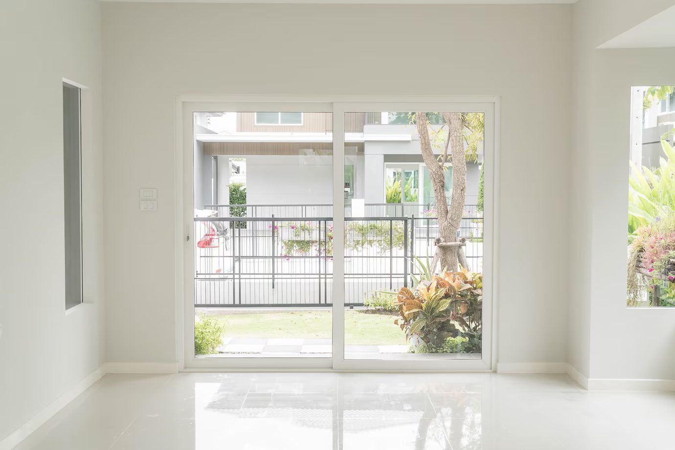 beige home exterior with white garage doors